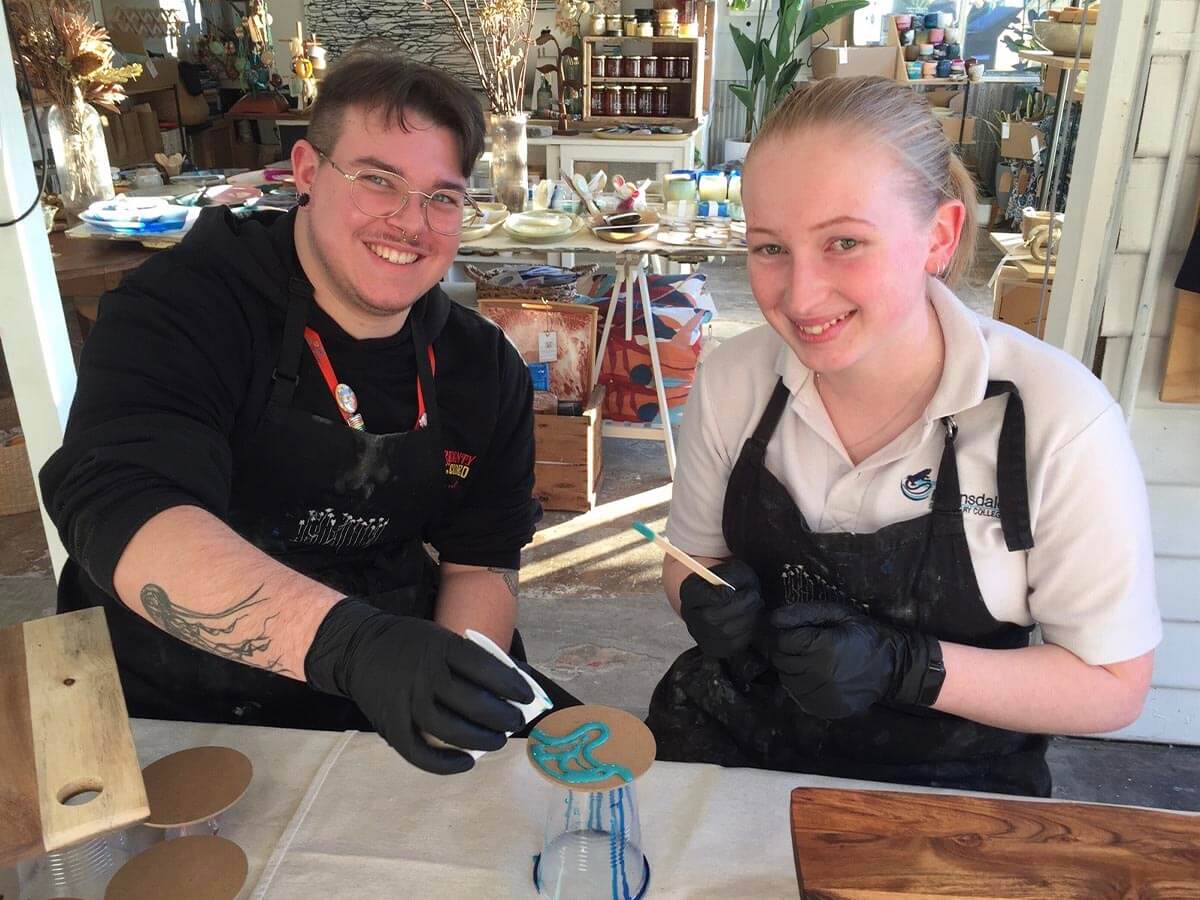 two young people creating resin art masterpieces during Youth Week
