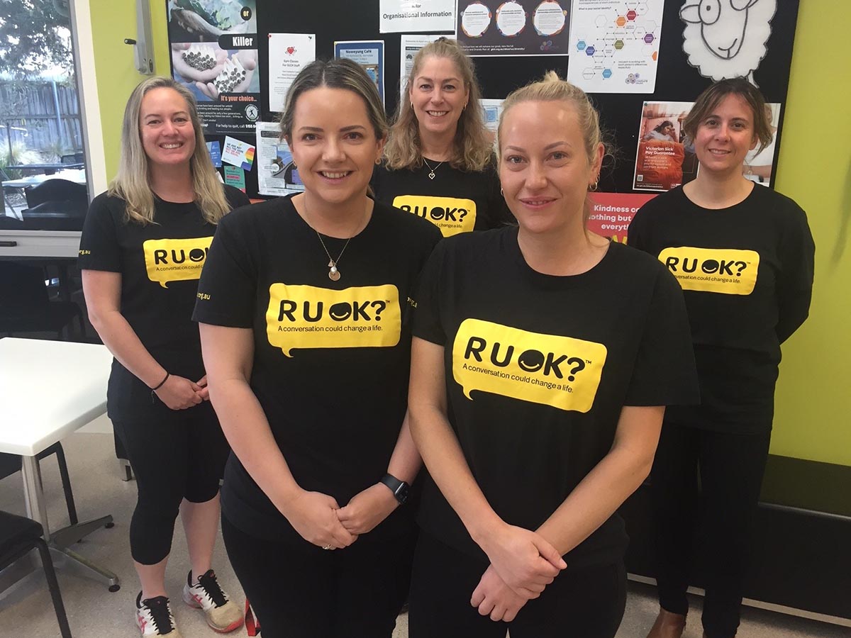 five staff members wearing RU OK t-shirts