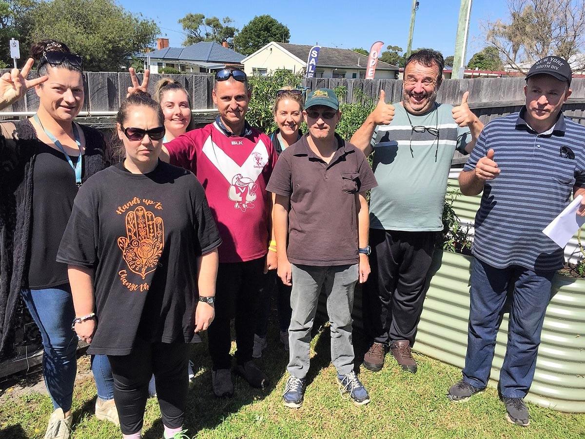 Social Support Group, The Lounge Crew standing in the garden at our Lakes Entrance location