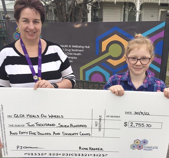 Executive Manager of Aged and Disability Services Penny pictured with Rose and an oversized cheque